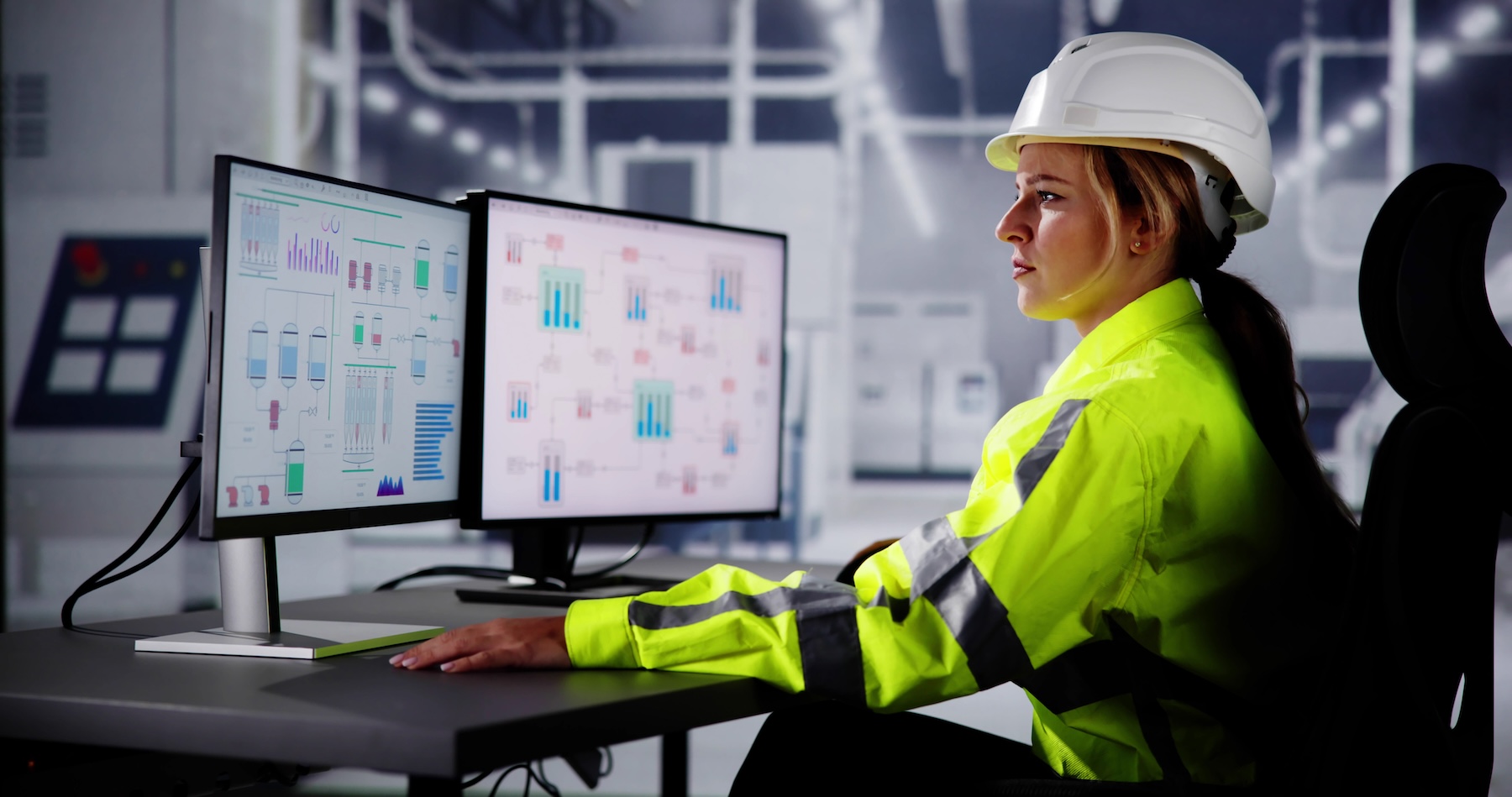 Engineer sitting at a desk looking at computer monitors